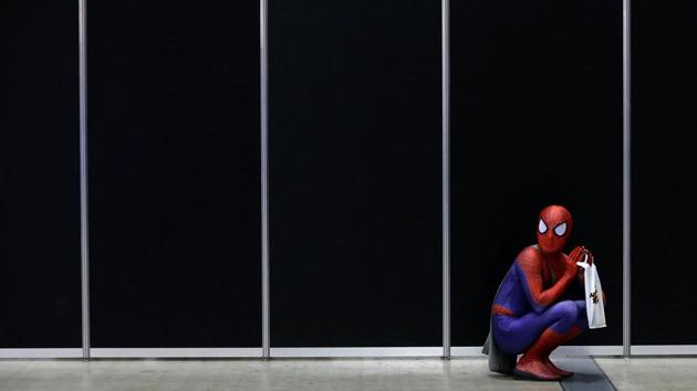 A fan in a Spider-Man costume takes a rest at Tokyo Comic Con. (REUTERS)