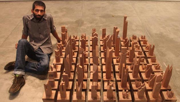 Artist Bhuvanesh Gowda with his artwork which will be on display at Chemould Prescott Road Gallery in Mumbai.(Bhushan Koyande) Artist Bhuvanesh Gowda with his artwork which will be on display at Chemould Prescott Road Gallery in Mumbai.(Bhushan Koyande)