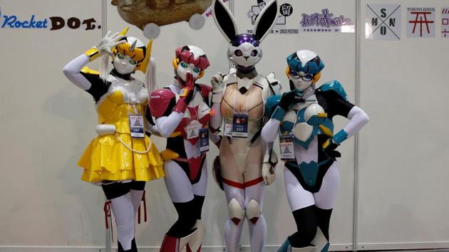 Women dressed in costumes pose for a photograph at Tokyo Comic Con at Makuhari Messe in Chiba, Japan. (REUTERS)