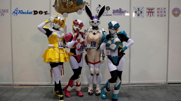 Women dressed in elaborate costumes pose at the Tokyo Comic Con. (REUTERS)