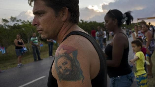 A man with a tattoo of Cuba'a late leader Fidel Castro, waits for the arrival of the caravan carrying his ashes during a funeral procession that retraces the path of Castro's triumphant march into Havana nearly six decades ago, in Cruces, Cuba.(AP File Photo)
