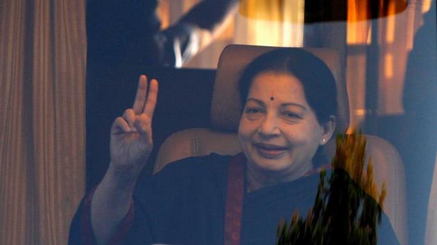 Here, Jayalalithaa  gestures from inside a vehicle after addressing her party supporters during an election campaign rally in Chennai (REUTERS) 