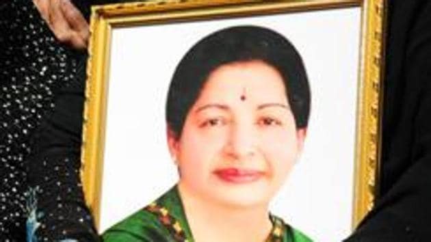 A woman holds a portrait of Tamil Nadu chief minister Jayalalithaa Jayaram as she prays for her recovery. (AFP Photo) A woman holds a portrait of Tamil Nadu chief minister Jayalalithaa Jayaram as she prays for her recovery. (AFP Photo)
