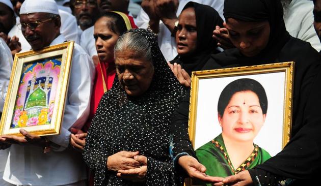 Indian Muslims hold a portrait of Tamil Nadu CM Jayalalitha Jayaram as they pray for her well being in front of a hospital.(ARUN SANKAR/AFP file photo)