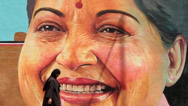 A woman walks past a portrait of Tamil Nadu chief minister J Jayalalithaa in Chennai.(Reuters)