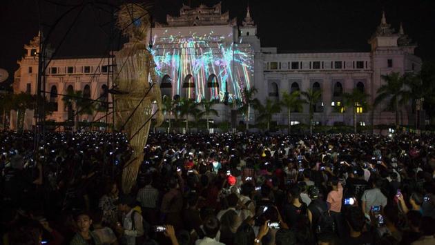 The wicker puppets provide an interesting backdrop to the light show played on the facade of Yangon city hall. (AFP)