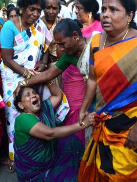 Supporters of Tamil Nadu?chief minister Jayalalithaa react outside the hospital where she is undergoing treatment after cardiac arrest on Sunday. (Srinivasulu/ HT Photo)