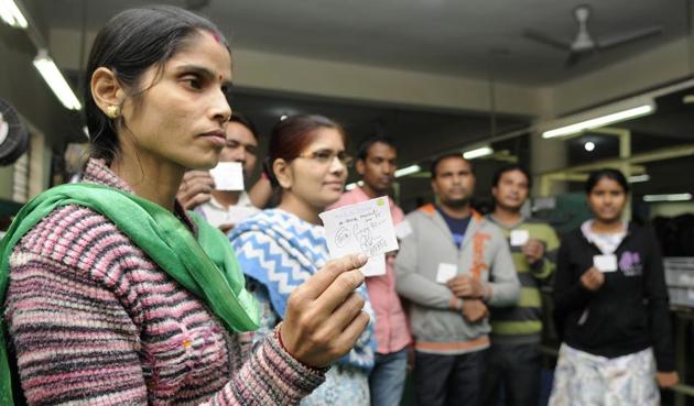 A worker holds up a coupon for purchase of goods worth Rs500 distributed at a factory, on Tuesday. (Sunil Ghosh/HT Photo) A worker holds up a coupon for purchase of goods worth Rs500 distributed at a factory, on Tuesday. (Sunil Ghosh/HT Photo)