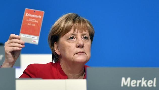 German Chancellor holds an voting ticket during a party conference of the Christian Democratic Union (CDU) in Essen, Germany, Tuesday, Dec. 6, 2016. (AP Photo) German Chancellor holds an voting ticket during a party conference of the Christian Democratic Union (CDU) in Essen, Germany, Tuesday, Dec. 6, 2016. (AP Photo)