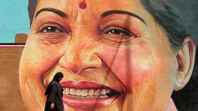 A woman walks past a portrait of J. Jayalalithaa, Chief Minister of the southern state of Tamil Nadu, in Chennai.(REUTERS)