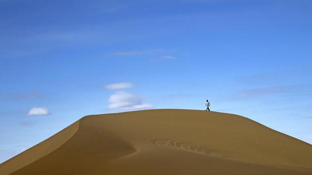 Deserts make up parts of Iran which have recently become tourist destination for young Iranians looking for a break on their weekend. An Iranian man walks on the sands while enjoying his weekend in the Mesr desert. (AP)