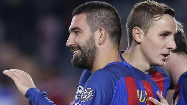 Barcelona's Arda Turan celebrates after scoring his side's 2nd goal during the Champions League Group C match against Borussia Moenchengladbach at the Camp Nou on Tuesday. Turan scored an hat-trick as Barcelona routed Moenchengladbach 4-0 to advance to the final 16 stage as group winners with 15 points. (AP) Barcelona's Arda Turan celebrates after scoring his side's 2nd goal during the Champions League Group C match against Borussia Moenchengladbach at the Camp Nou on Tuesday. Turan scored an hat-trick as Barcelona routed Moenchengladbach 4-0 to advance to the final 16 stage as group winners with 15 points. (AP)