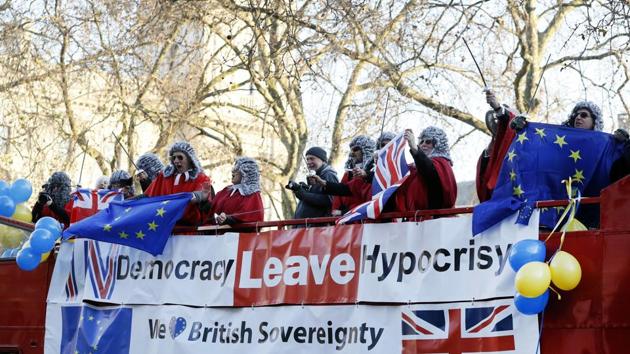 Demonstrators dressed in costume wave flags from the top of a bus outside The Supreme Court in London. (AP File Photo) Demonstrators dressed in costume wave flags from the top of a bus outside The Supreme Court in London. (AP File Photo)