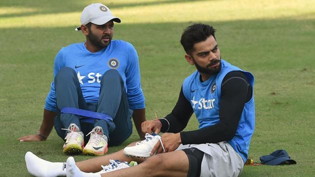 India's captain Virat Kohli (R) and Parthiv Patel watch teammates during the training session. (AFP) India's captain Virat Kohli (R) and Parthiv Patel watch teammates during the training session. (AFP)