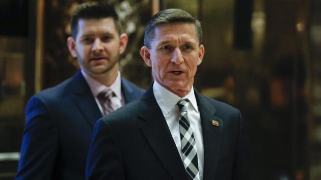 File photo of retired Lt Gen Michael Flynn talking to the media with his son Michael G Flynn (left) at Trump Tower in New York. Michael G Flynn tweeted about the false news that prompted a shooting at a Washington pizza parlour. Vice president-elect Mike Pence acknowledged on Tuesday that the younger Flynn was helping his father with scheduling and administrative items during the presidential transition but told CNN "that's no longer the case". (AP) File photo of retired Lt Gen Michael Flynn talking to the media with his son Michael G Flynn (left) at Trump Tower in New York. Michael G Flynn tweeted about the false news that prompted a shooting at a Washington pizza parlour. Vice president-elect Mike Pence acknowledged on Tuesday that the younger Flynn was helping his father with scheduling and administrative items during the presidential transition but told CNN "that's no longer the case". (AP)