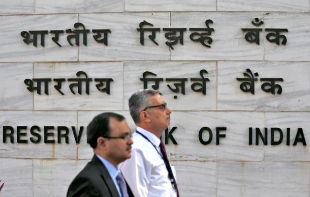 A file photo of people walking past the Reserve Bank of India head office in Mumbai. The central bank has refused to give information about whether the finance minister and chief economic advisor were consulted before the demonetisation decision was taken.(Reuters)
