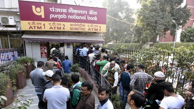 People stand in queue outside the PNB ATM to withdraw cash at Patel Chowk in New Delhi.(Sonu Mehta/HT Photo)