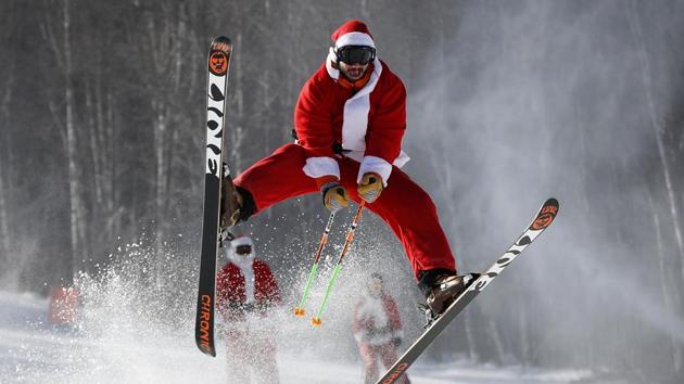 A skier dressed as Santa Claus catches some air during the annual Santa Sunday charity run on December 4, 2016 at the Sunday River Ski Resort in Newry, Maine. (AP) A skier dressed as Santa Claus catches some air during the annual Santa Sunday charity run on December 4, 2016 at the Sunday River Ski Resort in Newry, Maine. (AP)