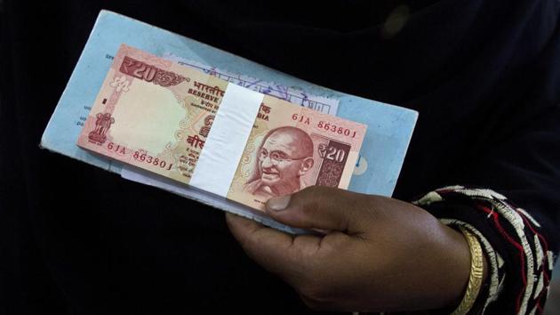 An Indian woman holds currency notes of smaller denomination after depositing discontinued currency at a bank in Mayong village near Gauhati, Assam on November 12. (AP Photo) An Indian woman holds currency notes of smaller denomination after depositing discontinued currency at a bank in Mayong village near Gauhati, Assam on November 12. (AP Photo)
