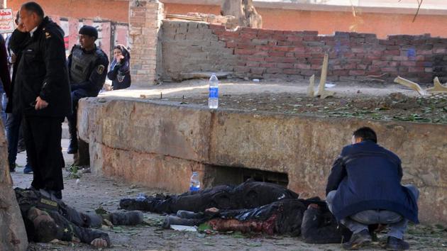 Egyptians check bodies at the site of a bomb attack next to a police checkpoint in Talibiya district of Cairo on December 9, 2016. (AFP) Egyptians check bodies at the site of a bomb attack next to a police checkpoint in Talibiya district of Cairo on December 9, 2016. (AFP)