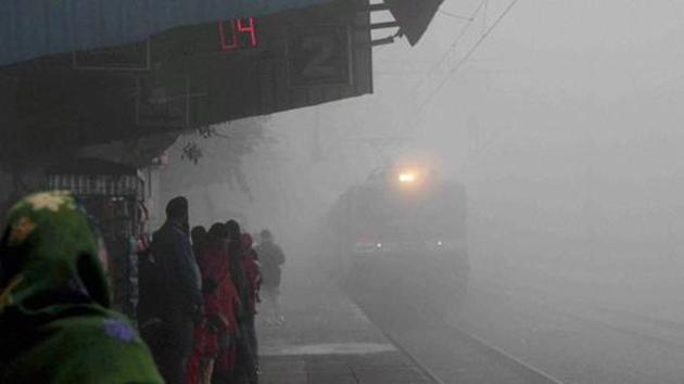 A train arrives at Faridabad Railway Station amid dense fog on Thursday. Many trains are running late or being cancelled owing to fog.(PTI Photo)