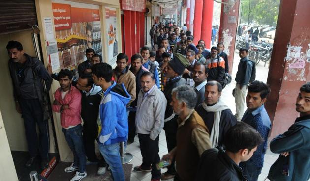 People queue up outside ICICI Bank in Sector 14. Though the government has been pushing for a cashless economy, many people have their concerns on going digital. (Parveen Kumar/HT Photo) People queue up outside ICICI Bank in Sector 14. Though the government has been pushing for a cashless economy, many people have their concerns on going digital. (Parveen Kumar/HT Photo)