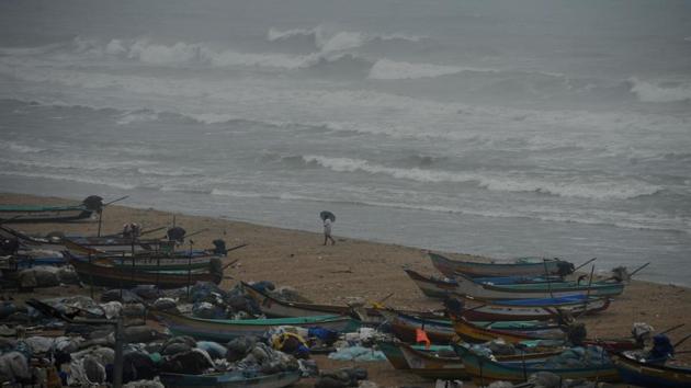 An Indian fisherman walks near boats as waves break on the cost of the Bay of Bengal in Chennai on Dec 1 when cyclone Nada was forecast to make landfall. (AFP Photo/ Representative image) An Indian fisherman walks near boats as waves break on the cost of the Bay of Bengal in Chennai on Dec 1 when cyclone Nada was forecast to make landfall. (AFP Photo/ Representative image)