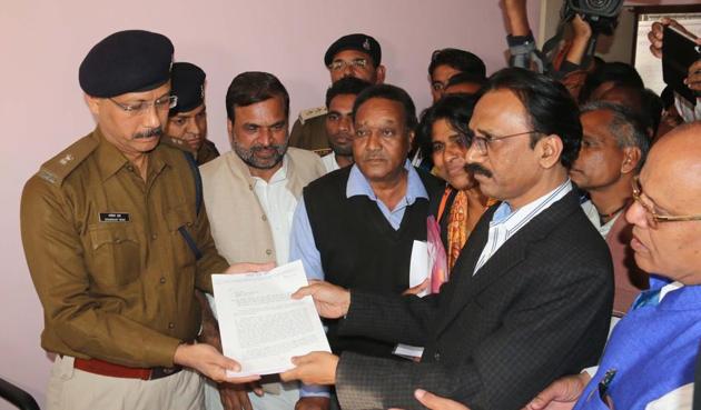 In January, Karnawat and another Dalit IAS officer Ramesh Thete (in pic submitting a memorandum to a police officer) participated in a dharna, organised by a Dalit adivasi forum.(File photo)