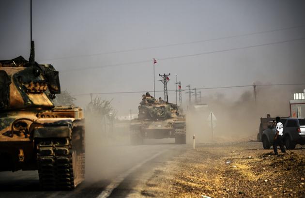 This picture taken around 5 kilometres west from the Turkish Syrian border city of Karkamis in the southern region of Gaziantep, on August 25, 2016 shows Turkish Army tanks driving to the Syrian Turkish border town of Jarabulus. Turkey's army backed by international coalition air strikes launched an operation involving fighter jets and elite ground troops to drive Islamic State jihadists out of a key Syrian border town. (AFP) This picture taken around 5 kilometres west from the Turkish Syrian border city of Karkamis in the southern region of Gaziantep, on August 25, 2016 shows Turkish Army tanks driving to the Syrian Turkish border town of Jarabulus. Turkey's army backed by international coalition air strikes launched an operation involving fighter jets and elite ground troops to drive Islamic State jihadists out of a key Syrian border town. (AFP)