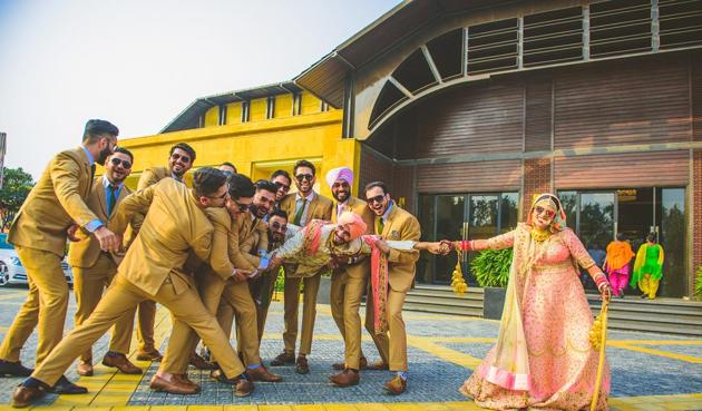 Matching outfits for the bridesmaids and groomsmen are in trend. Here, the groomsmen make a stylish mark at Rinee and Preet’s wedding wearing matching mustard suits.(Paran Singh Photography)