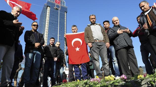 Mourning people pray near the explosion site at the Besiktas football club stadium Vodafone Arena in Istanbul, on Sunday. (AP) Mourning people pray near the explosion site at the Besiktas football club stadium Vodafone Arena in Istanbul, on Sunday. (AP)