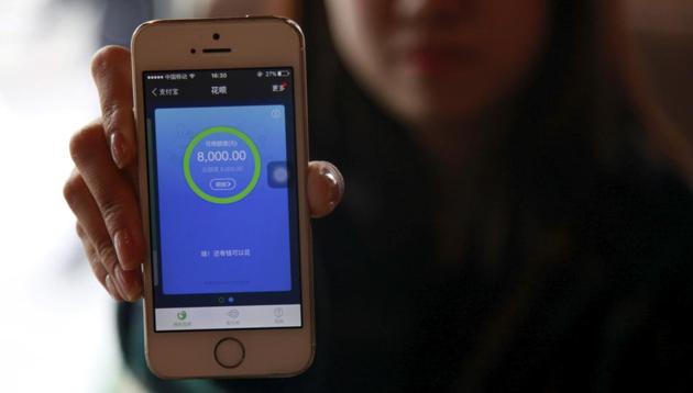 A woman shows her phone operating Ant Check, an Alibaba-linked platform, at a cafe in Beijing, China. (REUTERS) A woman shows her phone operating Ant Check, an Alibaba-linked platform, at a cafe in Beijing, China. (REUTERS)