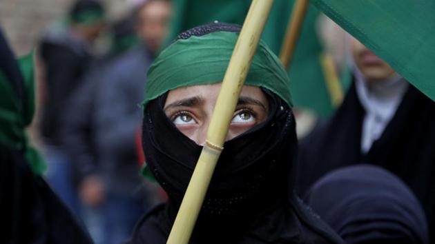 A Kashmiri Muslim girl holds a flag as she participates in a procession to celebrate Eid-e-Milad in Srinagar. (Mukhtar Khan / AP) A Kashmiri Muslim girl holds a flag as she participates in a procession to celebrate Eid-e-Milad in Srinagar. (Mukhtar Khan / AP)