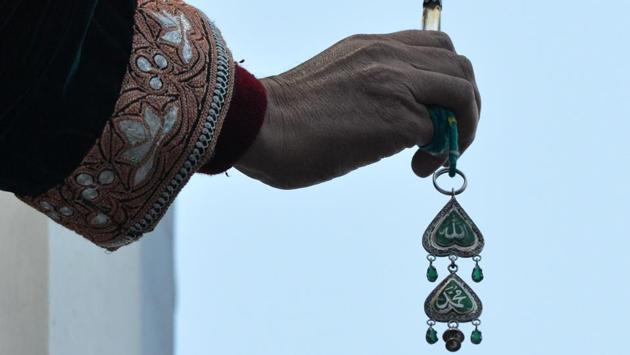 A Kashmiri Muslim cleric displays a holy relic believed to contain a hair from the beard of Prophet Muhammed during Eid-e-Milad-un-Nabi, the birthday of the Prophet, at the Hazratbal Shrine in Srinagar on December 12, 2016. ( TAUSEEF MUSTAFA / AFP PHOTO ) A Kashmiri Muslim cleric displays a holy relic believed to contain a hair from the beard of Prophet Muhammed during Eid-e-Milad-un-Nabi, the birthday of the Prophet, at the Hazratbal Shrine in Srinagar on December 12, 2016. ( TAUSEEF MUSTAFA / AFP PHOTO )