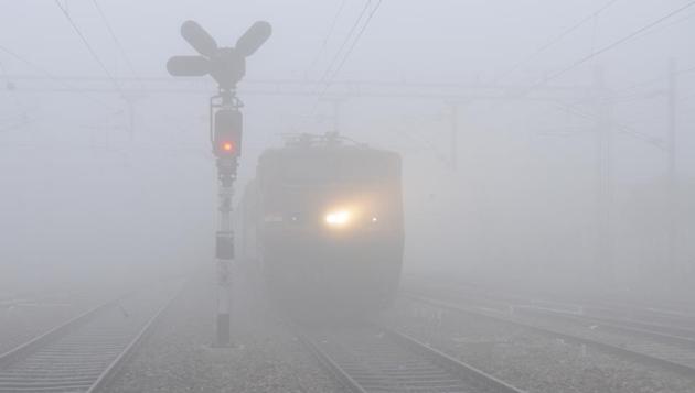 A train chugs through dense fog near Jalandhar on Monday, December 12 (Pardeep Pandit/HT)