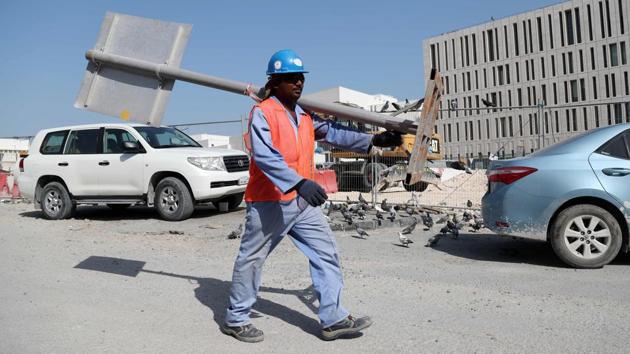 A migrant worker carries a pole at a construction site in the Qatari capital Doha. Ever since being chosen as the 2022 World Cup host, Qatar's labour laws have been internationally condemned and kafala has been at the heart of that criticism. (AFP) A migrant worker carries a pole at a construction site in the Qatari capital Doha. Ever since being chosen as the 2022 World Cup host, Qatar's labour laws have been internationally condemned and kafala has been at the heart of that criticism. (AFP)