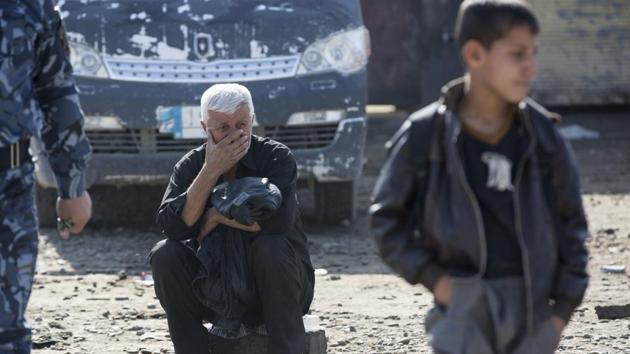 An Iraqi man who has just fled Mosul waits for transport to a camp for displaced people at a collection point in Gogjali, Iraq. Residents fleeing the fighting in Mosul recounted two years of brutality under the rule of the Islamic State group, which carried out murderous public punishments, purged Kurds, Shiites, Christians and other minorities and instilled widespread fear, turning a once thriving, multicultural city into a place of darkness.(AP Photo) An Iraqi man who has just fled Mosul waits for transport to a camp for displaced people at a collection point in Gogjali, Iraq. Residents fleeing the fighting in Mosul recounted two years of brutality under the rule of the Islamic State group, which carried out murderous public punishments, purged Kurds, Shiites, Christians and other minorities and instilled widespread fear, turning a once thriving, multicultural city into a place of darkness.(AP Photo)