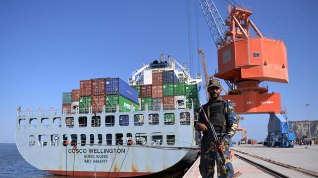 A Pakistani Naval personnel stands guard near a ship carrying containers at the Gwadar port during the opening ceremony of a pilot trade programme between Pakistan and China.(AFP file photo)