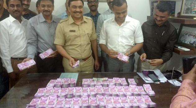 The police with the seized currency.(HT)