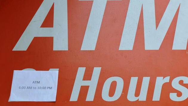 Timings pasted over ‘24’ at an ATM in Chandigarh on Tuesday, December 13. (Ravi Kumar/HT)