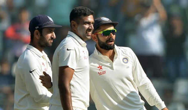 India captain Virat Kohli (R) celebrates with Ravichandran Ashwin (C) and Cheteshwar Pujara after the dismissal of England's Chris Woakes on the final day of the fourth Test cricket match between India and England. (AFP) India captain Virat Kohli (R) celebrates with Ravichandran Ashwin (C) and Cheteshwar Pujara after the dismissal of England's Chris Woakes on the final day of the fourth Test cricket match between India and England. (AFP)