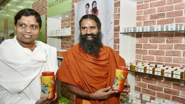 Yog Guru Baba Ramdev and Acharya Balkrishna showing their “Patanjali” products before addressing a Press Conference in New Delhi on Tuesday, April 26, 2016.(HT File Photo)