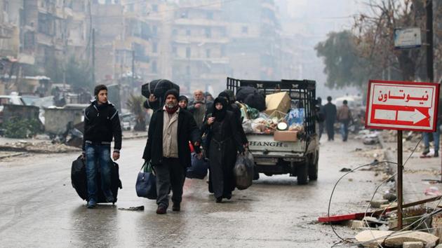 People carry their belongings as they flee deeper into the remaining rebel-held areas of Aleppo, Syria.(REUTERS) People carry their belongings as they flee deeper into the remaining rebel-held areas of Aleppo, Syria.(REUTERS)