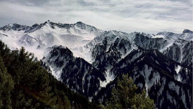 A view of snow-covered upper reaches of Peer Panchal Range as pictured from Poonch in Jammu and Kashmir on Friday. (PTI)