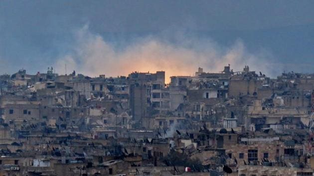 A general view shows smoke and flames rising from buildings in Aleppo's southeastern al-Zabdiya neighbourhood following government strikes on December 14, 2016.(AFP)