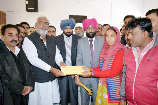 State health minister Surjit Kumar Jiyani handing over an appointment letter to one of the family members in Fazilka on Wednesday.(HT Photo)