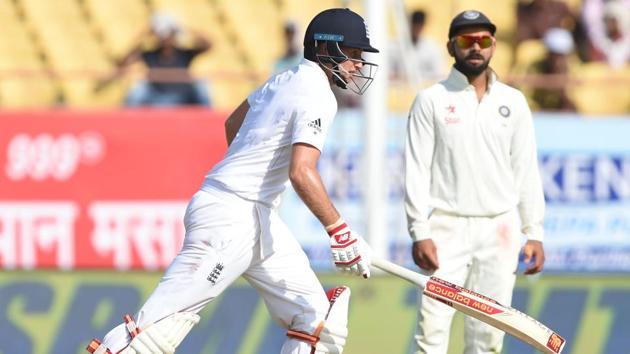 England's Joe Root runs between the wickets as India captain Virat Kohli looks on on the first day of the first Test in Rajkot on November 9, 2016(AFP)