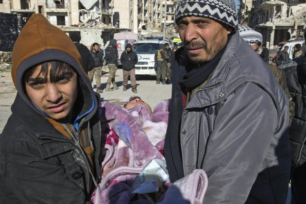 A Syrian child being carried for the evacuation operation. The rebel withdrawal will pave the way for President Bashar al-Assad's forces to reclaim complete control of Syria's second city, handing the regime its biggest victory in more than five years of civil war. (AFP)