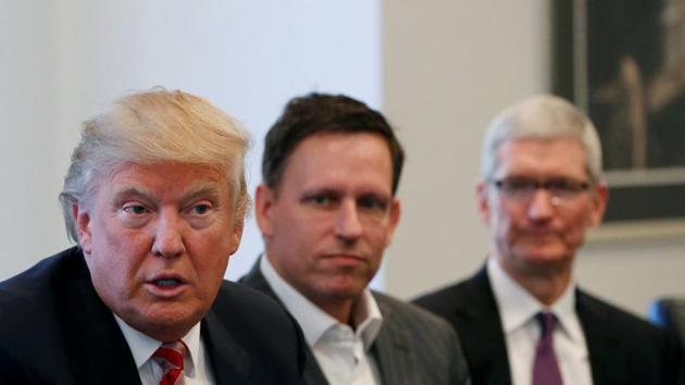 US president-elect Donald Trump speaks as PayPal co-founder and Facebook board member Peter Thiel (centre), and Apple Inc CEO Tim Cook (right) look on during a meeting with technology leaders at Trump Tower in New York. (Reuters Photo) US president-elect Donald Trump speaks as PayPal co-founder and Facebook board member Peter Thiel (centre), and Apple Inc CEO Tim Cook (right) look on during a meeting with technology leaders at Trump Tower in New York. (Reuters Photo)