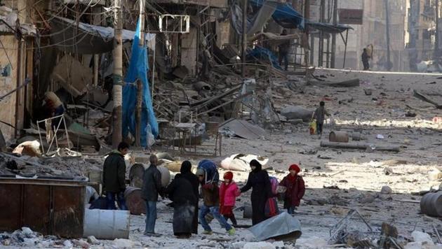 Syrians walk over rubble of damaged buildings, while carrying their belongings, as they flee clashes between government forces and rebels in Tariq al-Bab and al-Sakhour neighborhoods of eastern Aleppo towards other rebel held besieged areas of Aleppo. (Reuters)